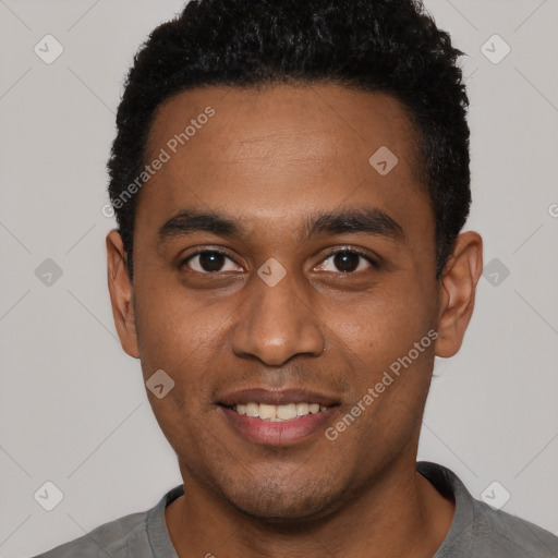 Joyful black young-adult male with short  black hair and brown eyes