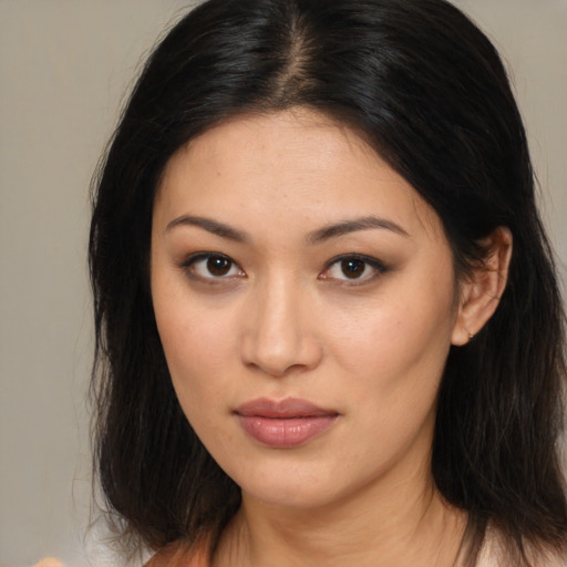 Joyful asian young-adult female with medium  brown hair and brown eyes