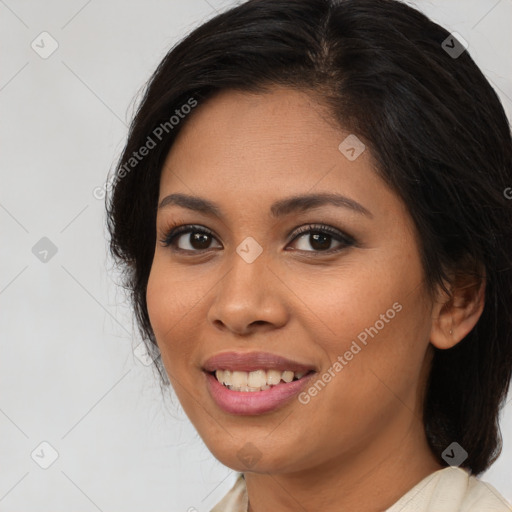 Joyful latino young-adult female with medium  brown hair and brown eyes