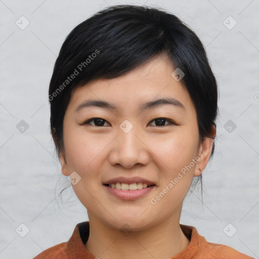 Joyful asian young-adult female with medium  black hair and brown eyes