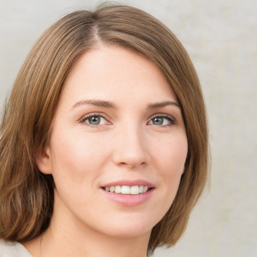 Joyful white young-adult female with medium  brown hair and green eyes