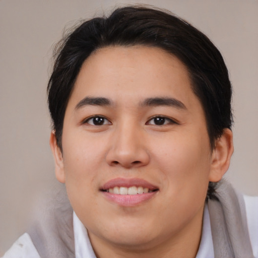 Joyful asian young-adult male with medium  brown hair and brown eyes