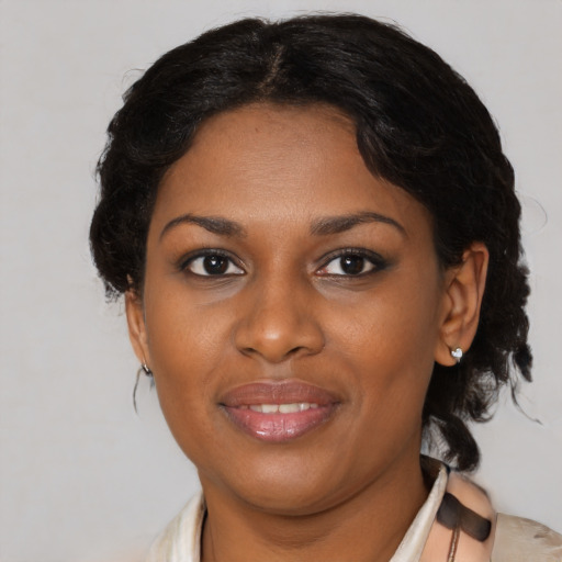 Joyful black young-adult female with medium  brown hair and brown eyes