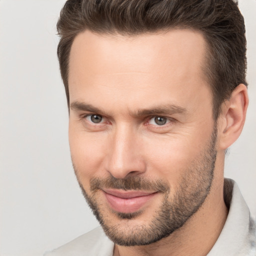 Joyful white adult male with short  brown hair and brown eyes