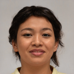 Joyful asian young-adult female with medium  brown hair and brown eyes