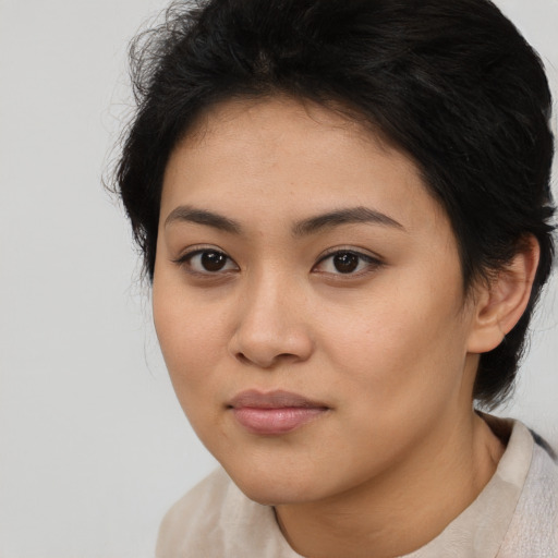 Joyful latino young-adult female with medium  black hair and brown eyes