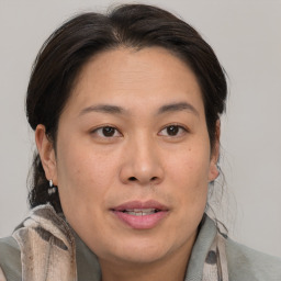 Joyful asian adult female with medium  brown hair and brown eyes