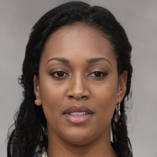 Joyful black young-adult female with long  black hair and brown eyes