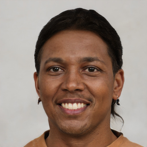 Joyful black adult male with short  black hair and brown eyes