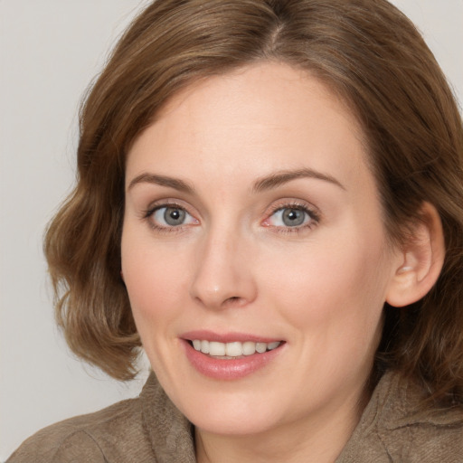 Joyful white young-adult female with medium  brown hair and blue eyes