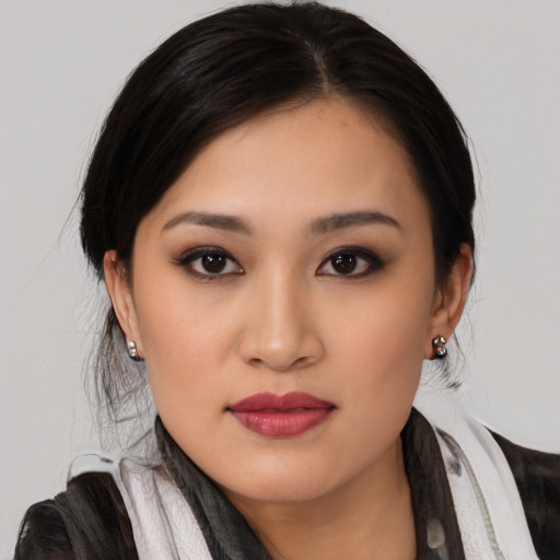 Joyful asian young-adult female with medium  black hair and brown eyes