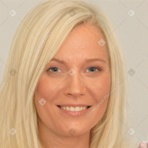 Joyful white adult female with long  blond hair and blue eyes