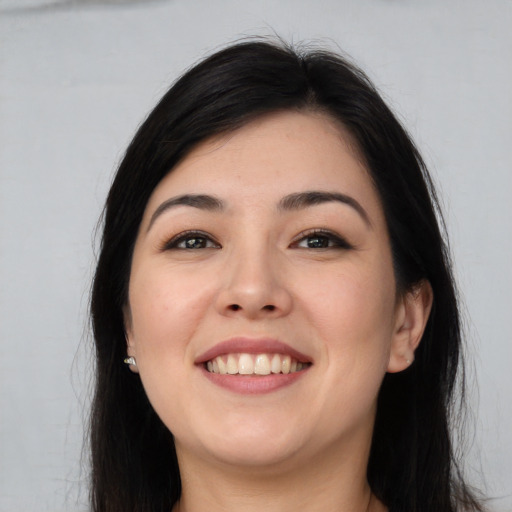 Joyful white young-adult female with long  brown hair and brown eyes