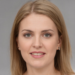 Joyful white young-adult female with long  brown hair and grey eyes