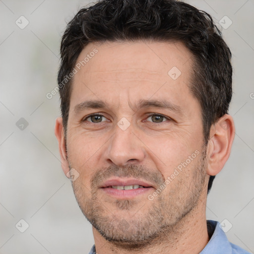 Joyful white adult male with short  brown hair and brown eyes