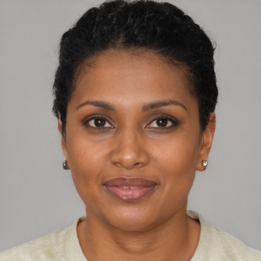Joyful black young-adult female with short  brown hair and brown eyes