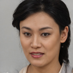 Joyful asian young-adult female with medium  brown hair and brown eyes