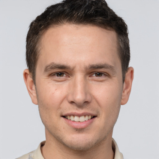 Joyful white young-adult male with short  brown hair and brown eyes