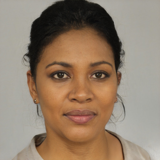 Joyful black young-adult female with short  black hair and brown eyes