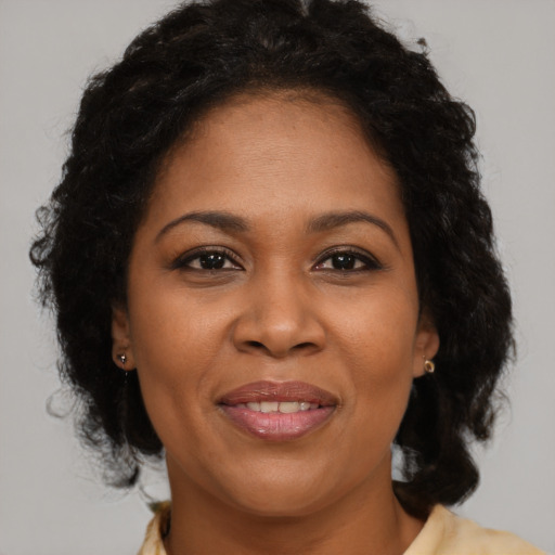 Joyful black adult female with medium  brown hair and brown eyes