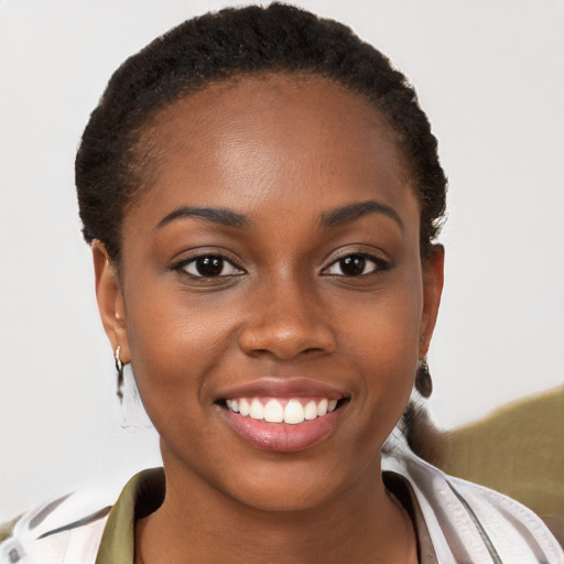 Joyful black young-adult female with short  brown hair and brown eyes