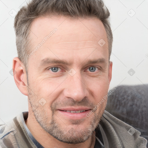 Joyful white adult male with short  brown hair and grey eyes