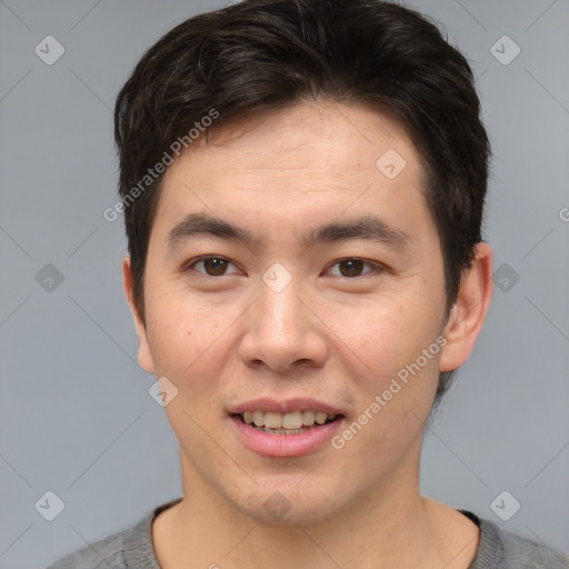 Joyful asian young-adult male with short  brown hair and brown eyes