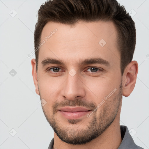 Joyful white young-adult male with short  brown hair and brown eyes