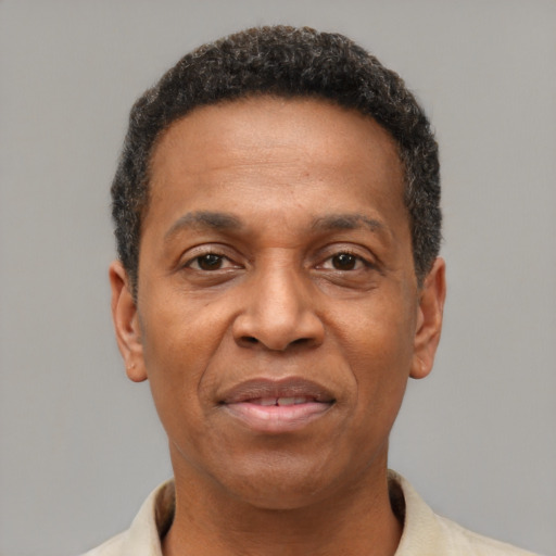 Joyful latino adult male with short  brown hair and brown eyes