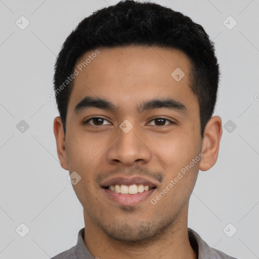 Joyful latino young-adult male with short  black hair and brown eyes