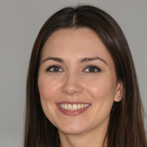 Joyful white young-adult female with long  brown hair and brown eyes