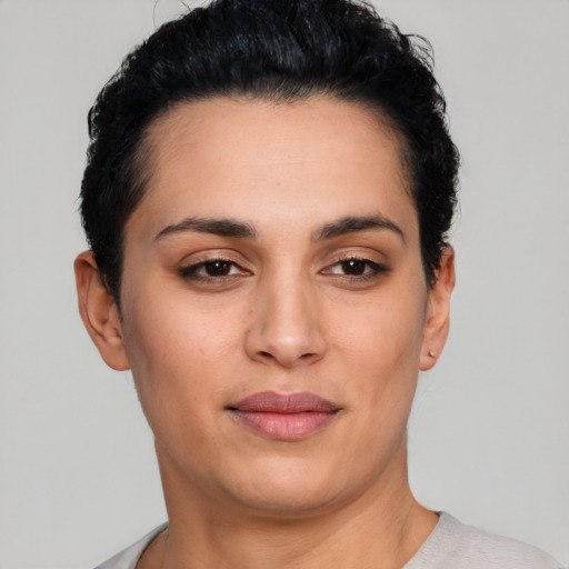 Joyful latino young-adult female with short  black hair and brown eyes