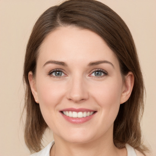 Joyful white young-adult female with medium  brown hair and green eyes