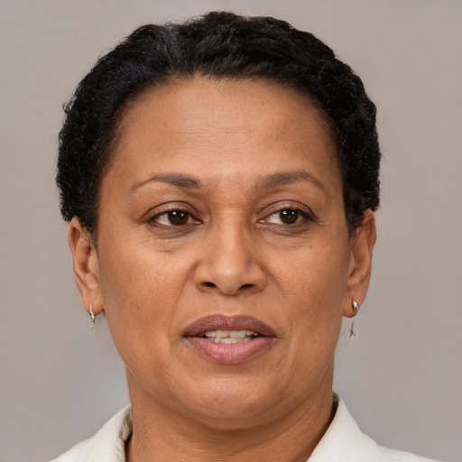 Joyful latino adult female with short  brown hair and brown eyes
