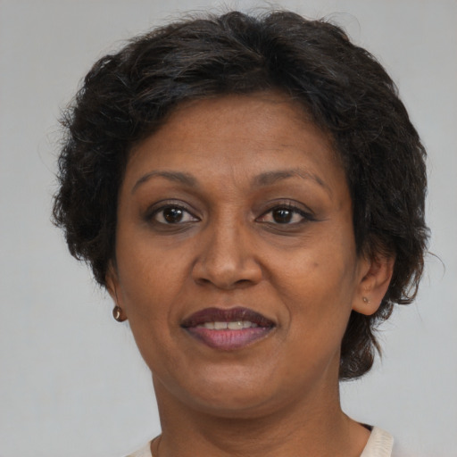 Joyful black adult female with medium  brown hair and brown eyes
