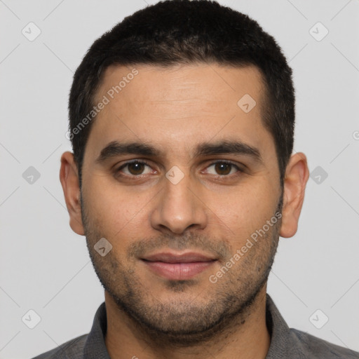 Joyful latino young-adult male with short  brown hair and brown eyes