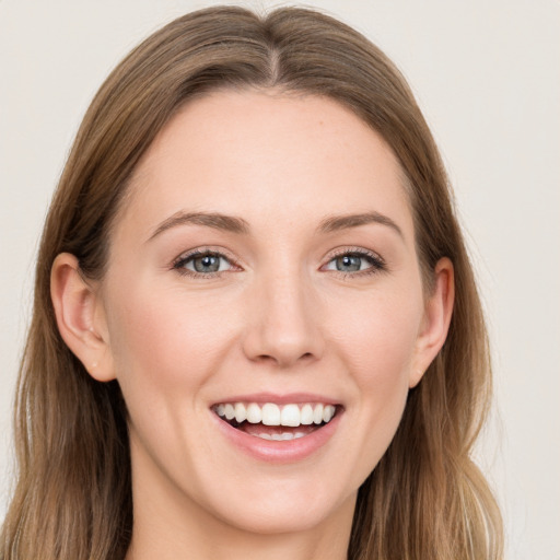 Joyful white young-adult female with long  brown hair and grey eyes