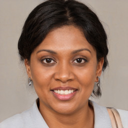 Joyful black young-adult female with medium  brown hair and brown eyes