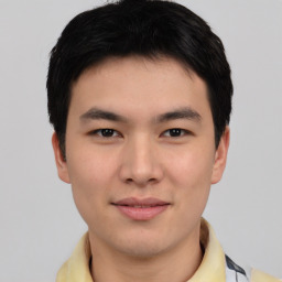 Joyful asian young-adult male with short  black hair and brown eyes