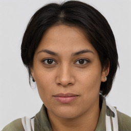 Joyful latino young-adult female with medium  brown hair and brown eyes