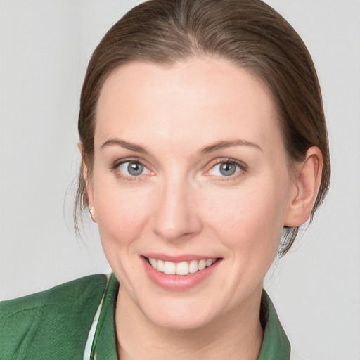 Joyful white young-adult female with medium  brown hair and blue eyes