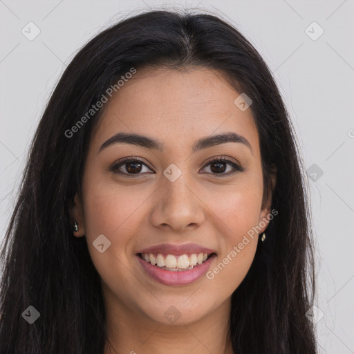 Joyful latino young-adult female with long  brown hair and brown eyes