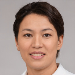 Joyful asian young-adult female with short  brown hair and brown eyes