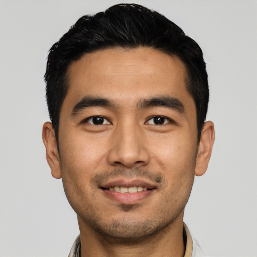 Joyful asian young-adult male with short  black hair and brown eyes
