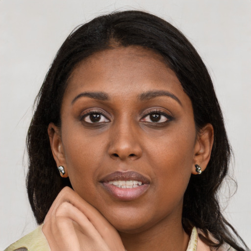 Joyful latino young-adult female with medium  brown hair and brown eyes