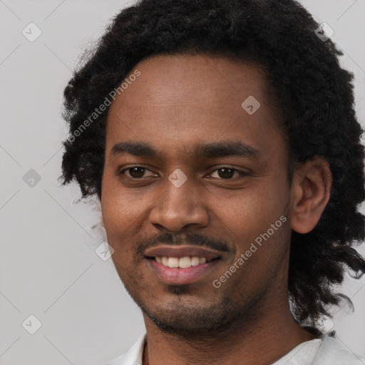 Joyful black young-adult male with short  black hair and brown eyes