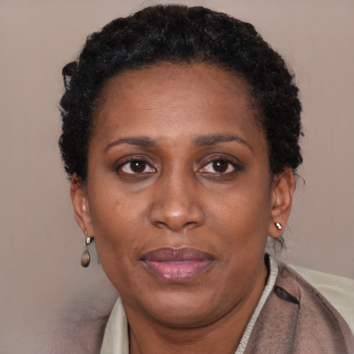 Joyful black adult female with short  brown hair and brown eyes
