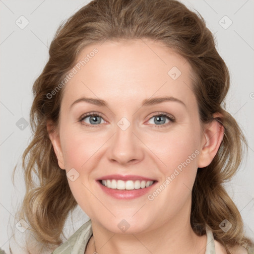 Joyful white young-adult female with medium  brown hair and green eyes