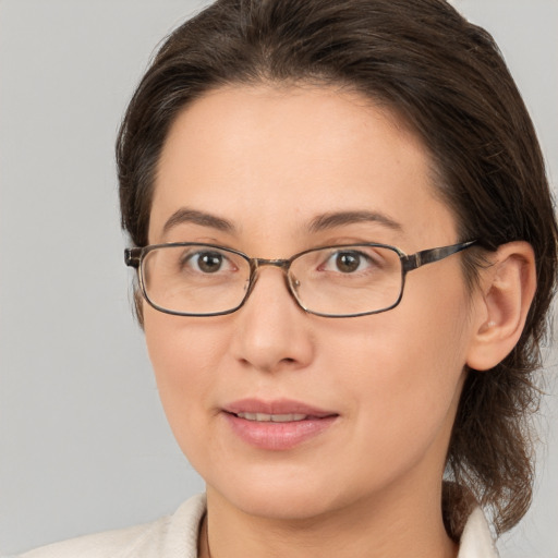 Joyful white young-adult female with medium  brown hair and brown eyes