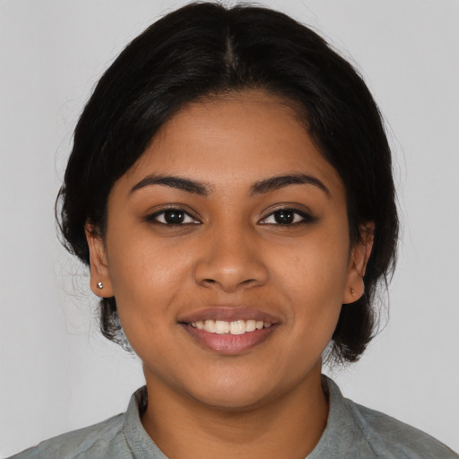 Joyful latino young-adult female with medium  black hair and brown eyes